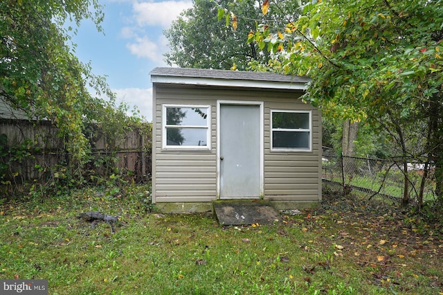 view of outbuilding with a lawn