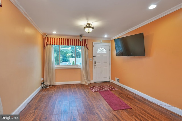 doorway with ornamental molding and dark hardwood / wood-style floors