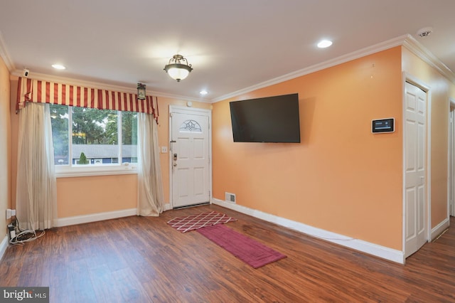 foyer with ornamental molding and dark wood-type flooring