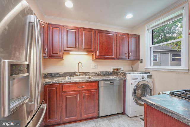 kitchen with crown molding, washer / clothes dryer, sink, and stainless steel appliances