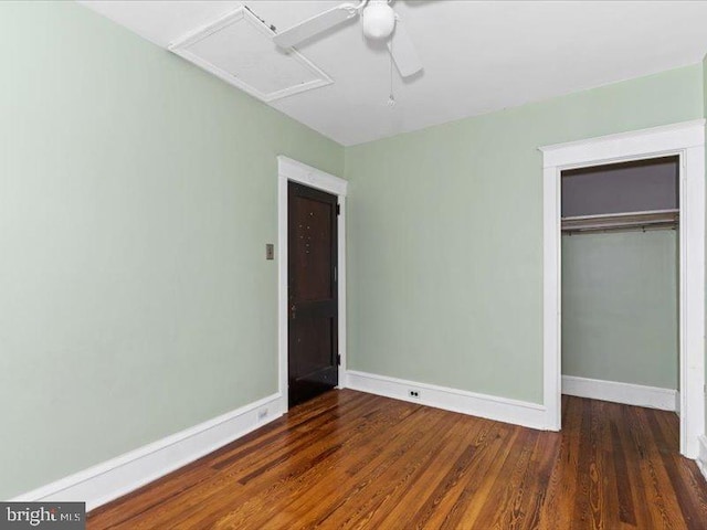 unfurnished bedroom featuring ceiling fan, a closet, and dark wood-type flooring