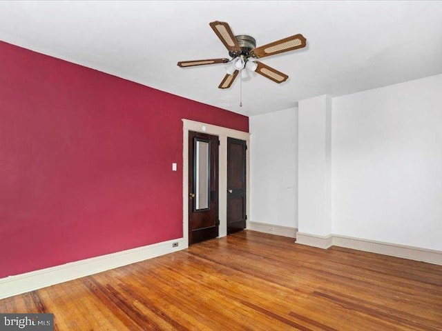 spare room featuring wood-type flooring and ceiling fan