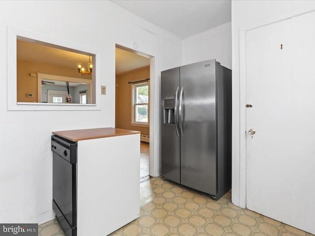 kitchen with stainless steel refrigerator with ice dispenser, baseboard heating, and dishwasher