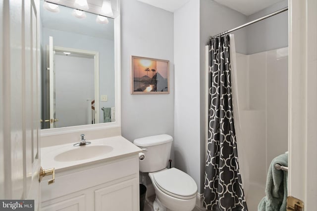 bathroom featuring vanity, toilet, and a shower with shower curtain