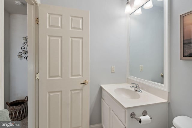 bathroom featuring vanity and toilet