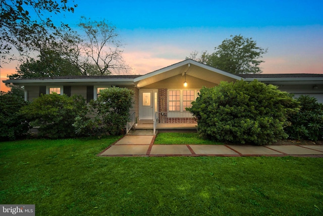 single story home featuring a yard