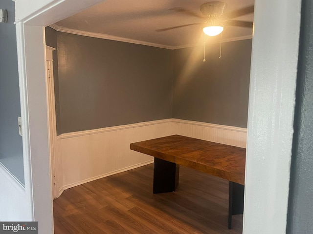 unfurnished dining area featuring crown molding, ceiling fan, and dark hardwood / wood-style floors