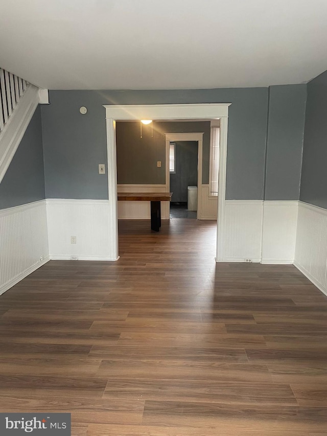 unfurnished room with dark hardwood / wood-style flooring