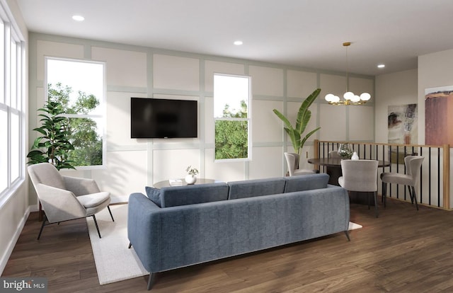 living room with an inviting chandelier and dark wood-type flooring