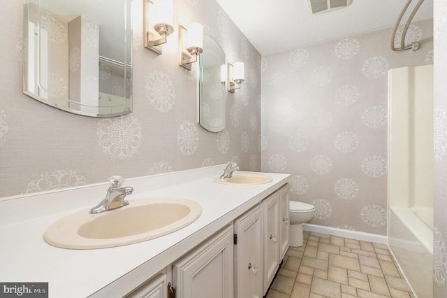 full bathroom featuring toilet, shower / bathing tub combination, and vanity