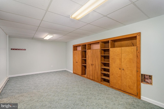 unfurnished bedroom with a drop ceiling, carpet floors, and a closet