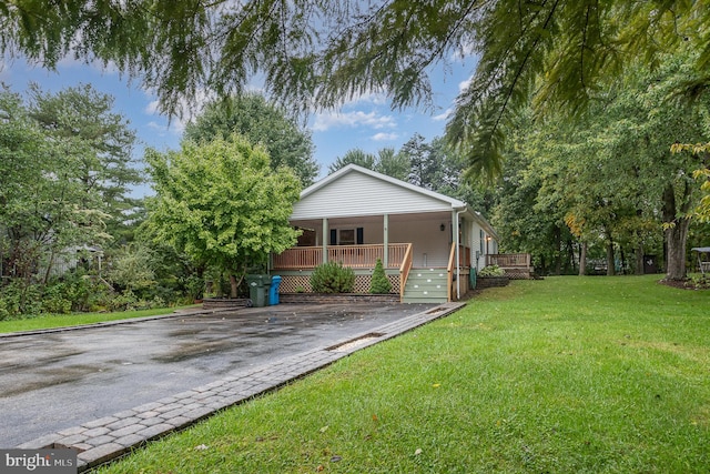 view of home's exterior with a wooden deck and a yard