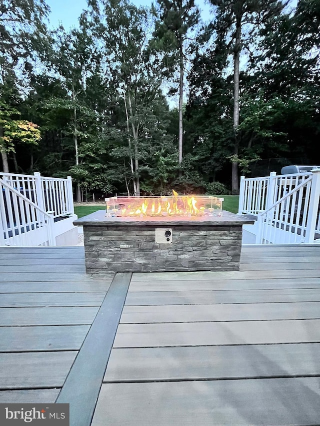 wooden terrace with a fire pit