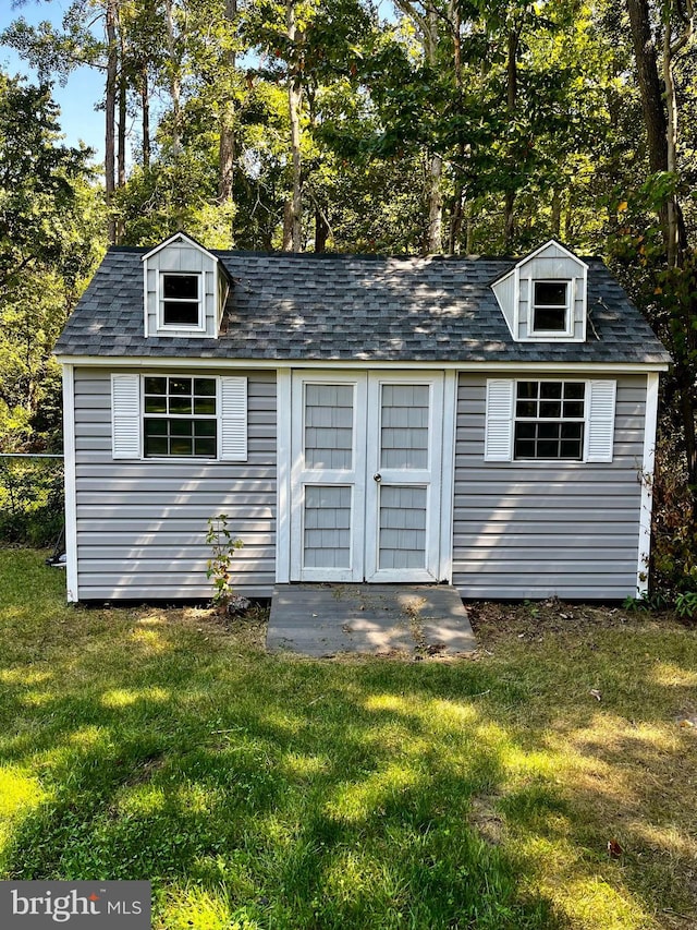 view of outdoor structure featuring a lawn