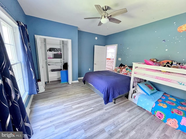 bedroom with ceiling fan and light hardwood / wood-style flooring