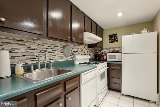 kitchen with tasteful backsplash, white appliances, light tile patterned floors, dark brown cabinets, and sink