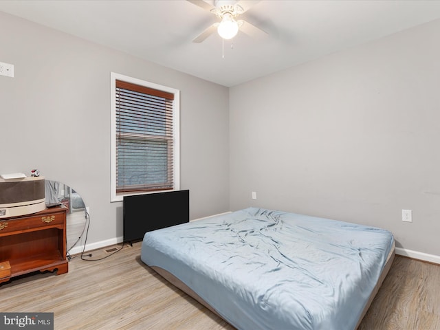 bedroom with ceiling fan and light wood-type flooring