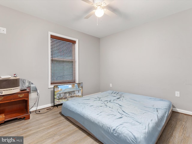 bedroom with light hardwood / wood-style floors and ceiling fan