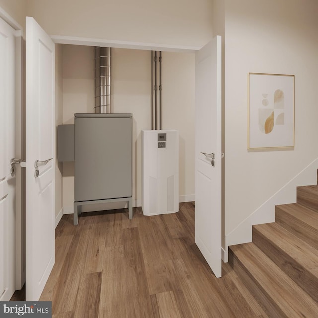 clothes washing area featuring hardwood / wood-style floors