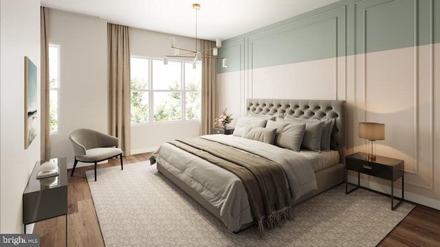 bedroom with a chandelier and dark hardwood / wood-style flooring