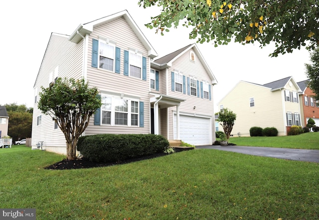 view of front of house with a front yard and a garage