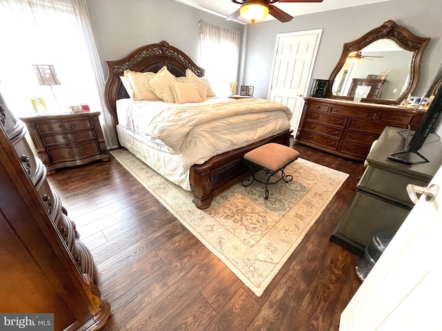 bedroom with ceiling fan and dark hardwood / wood-style floors