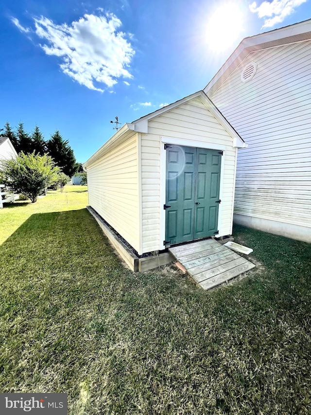 view of outbuilding with a yard