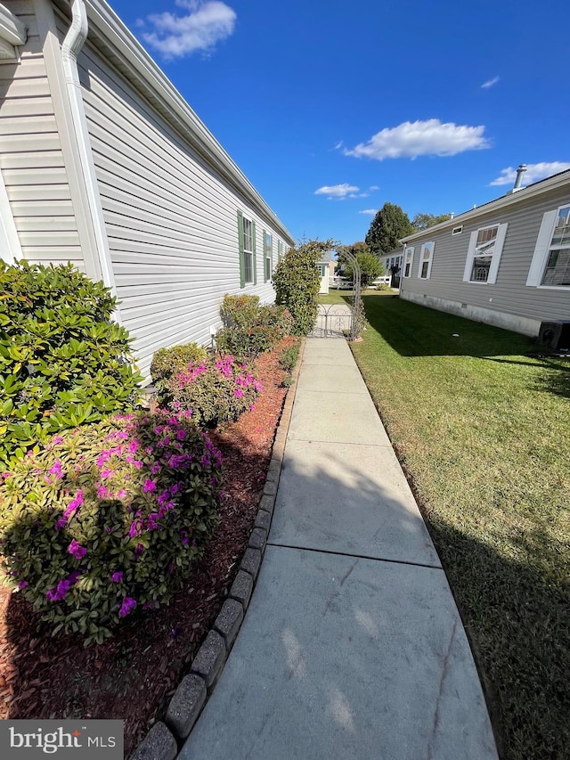 view of property exterior with a yard