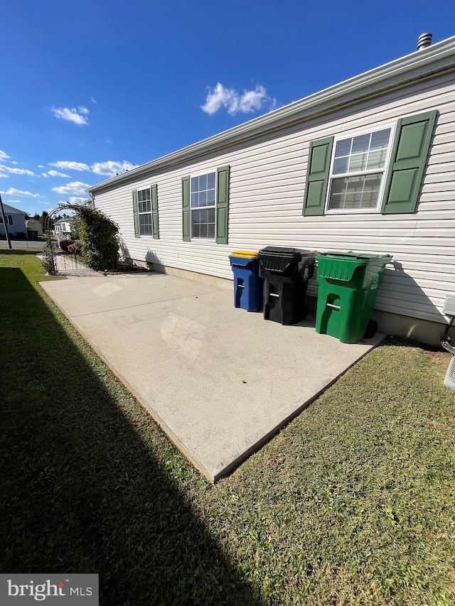 back of property with a patio and a lawn