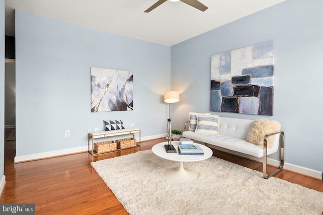 living room featuring hardwood / wood-style floors and ceiling fan