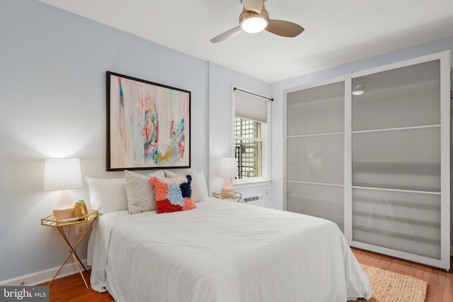 bedroom with wood-type flooring and ceiling fan