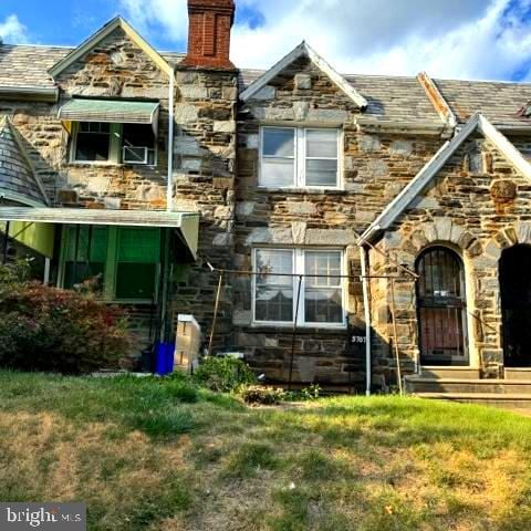 rear view of property with a lawn