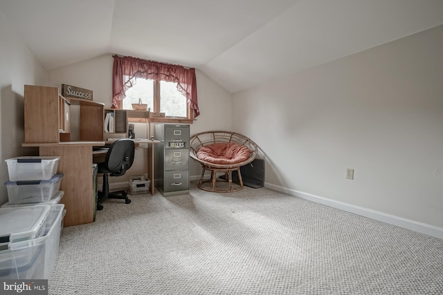 office area featuring vaulted ceiling and light colored carpet