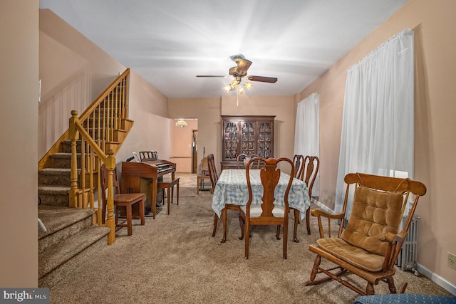 carpeted dining space featuring ceiling fan