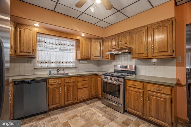 kitchen with a paneled ceiling, tasteful backsplash, stainless steel appliances, ceiling fan, and sink