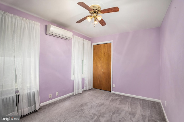 unfurnished room featuring ceiling fan, light carpet, and a wall unit AC