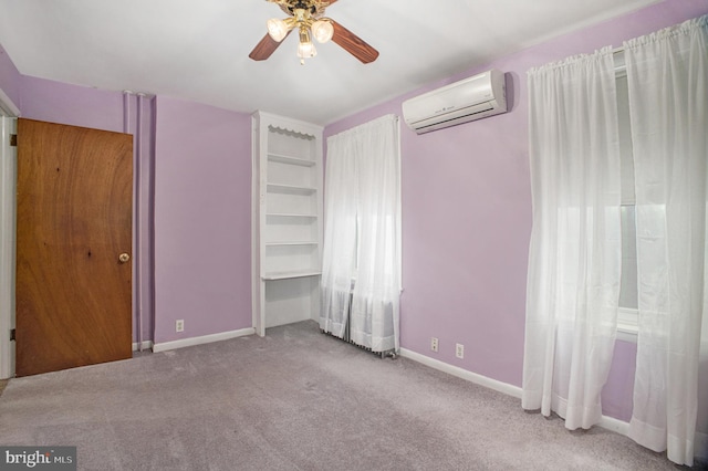 unfurnished bedroom featuring ceiling fan, light carpet, and a wall mounted AC