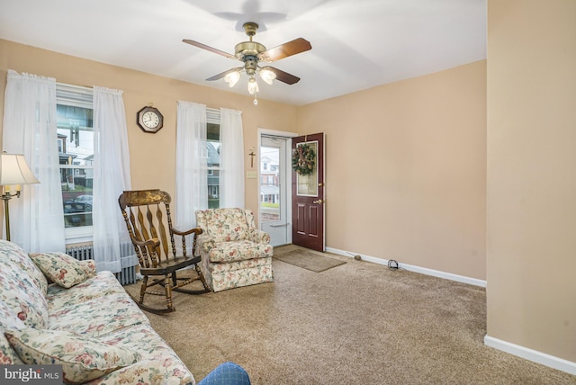 carpeted living room featuring ceiling fan