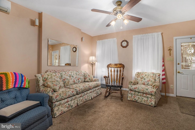 living room with a wall mounted AC, carpet flooring, and ceiling fan