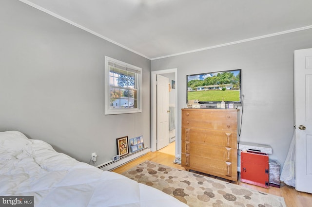 bedroom featuring wood-type flooring, ornamental molding, and a baseboard heating unit