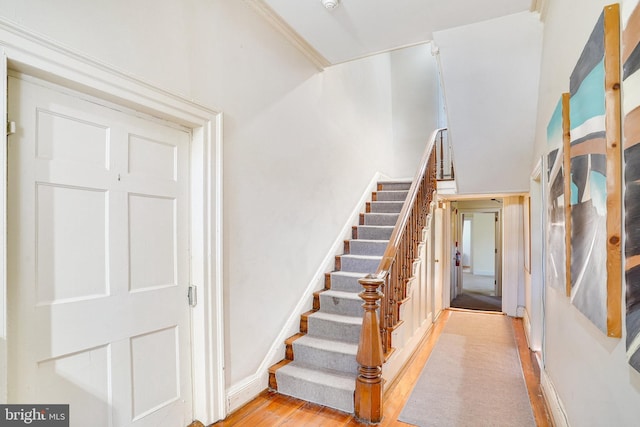 stairs with hardwood / wood-style floors