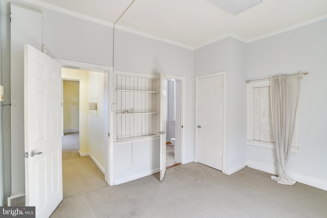 unfurnished bedroom with light carpet and crown molding