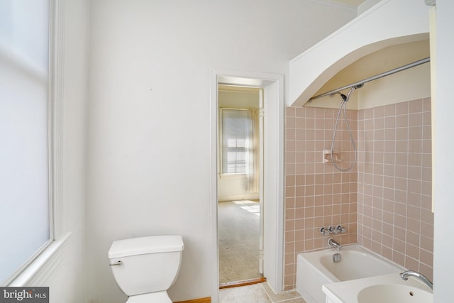 full bathroom featuring tiled shower / bath combo, tile patterned flooring, toilet, and sink