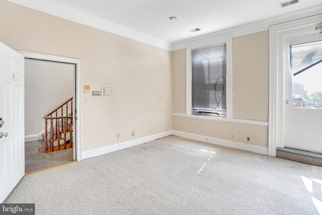 spare room with light carpet and ornamental molding