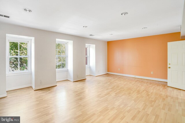 unfurnished room featuring light hardwood / wood-style flooring and a wealth of natural light