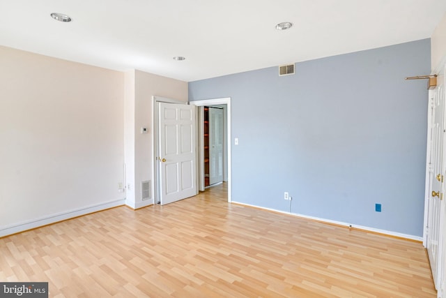 spare room with light hardwood / wood-style floors