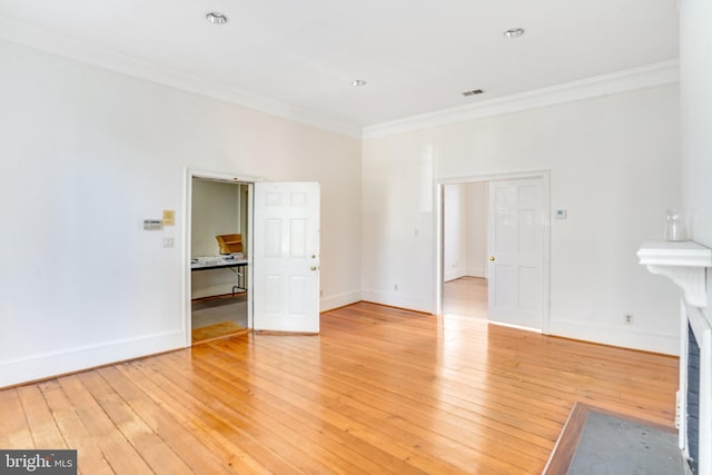 interior space featuring ornamental molding and light wood-type flooring