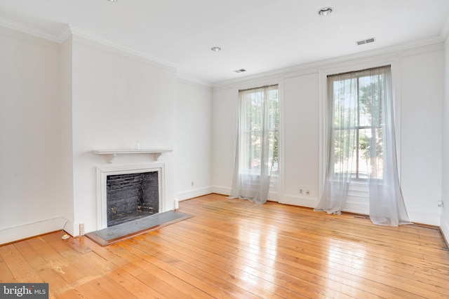 unfurnished living room with light wood-type flooring and crown molding