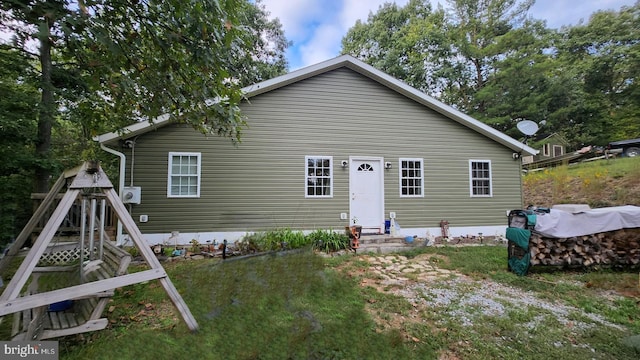 back of house with a lawn