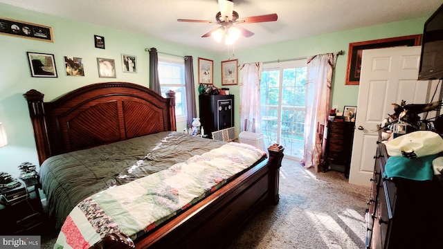 carpeted bedroom featuring ceiling fan and access to exterior